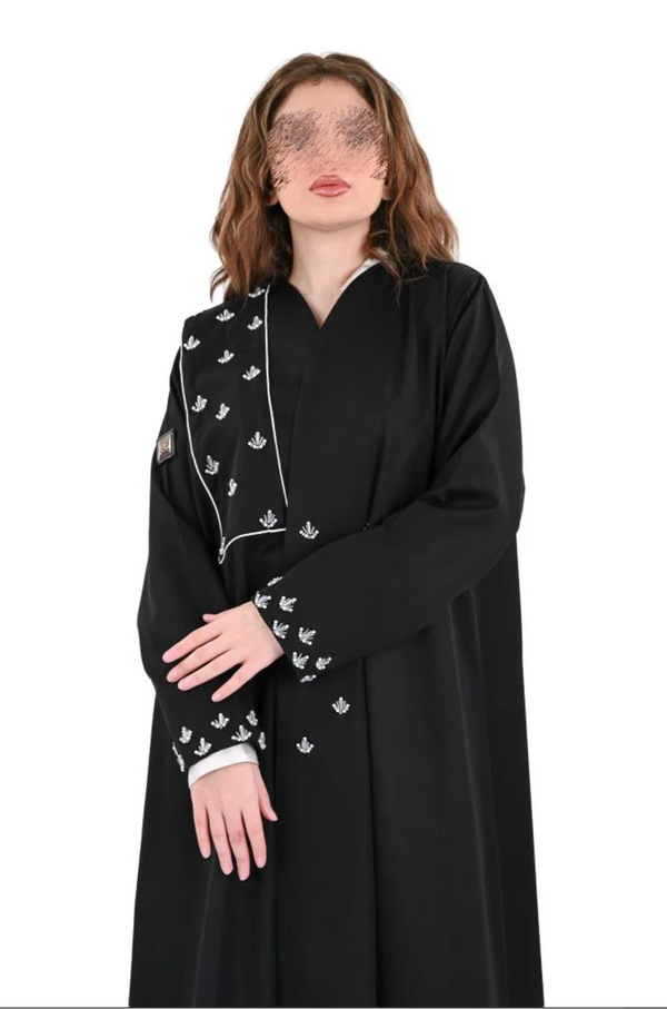 A flared abaya with hand-beaded embroidery